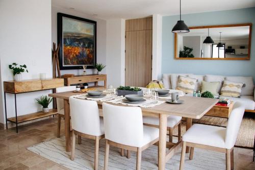 a dining room with a table and a couch at Deluxe Design Condo, San Miguel in San Miguel de Allende