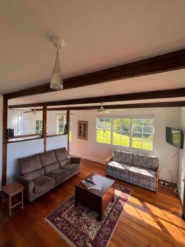 a living room with a couch and a tv at Valley View in Possum Brush