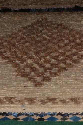 a brown rug with a pattern on the floor at White And Blue in Essaouira
