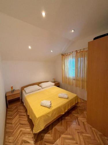 a bedroom with a bed with two towels on it at Apartments with parking space Bol, Brac - 12980 in Bol