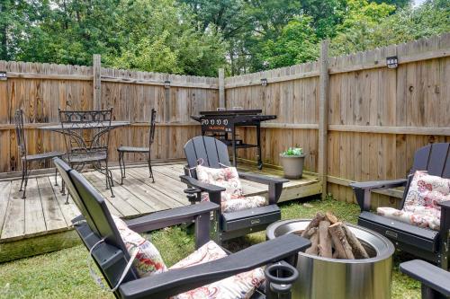 a backyard with chairs and a grill and a fence at Spacious 4BR Home with Cozy Vibes in Louisville in Louisville