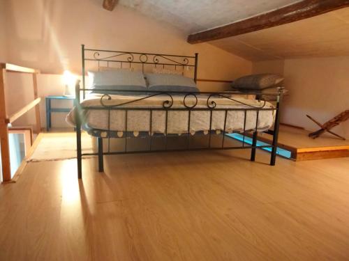 a bedroom with a metal bed in a attic at Stefy House in Lastra a Signa