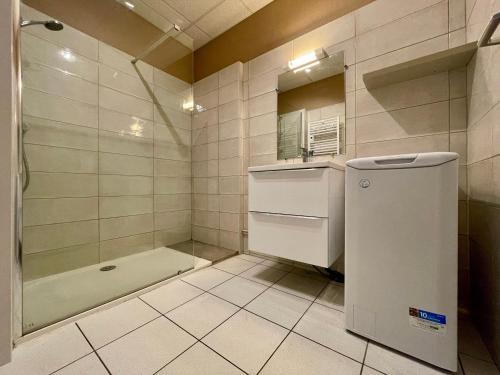 a small bathroom with a shower and a refrigerator at Gîte rénové 2018, au cœur de la nature, activités plein air, 3 chambres, jardin privatif, proche Via Fluvia - FR-1-582-261 in Saint-Julien-Molhesabate