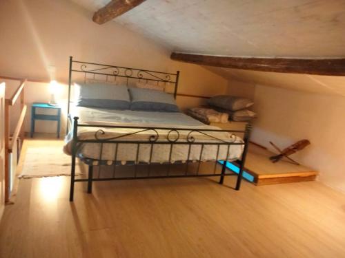 a bedroom with a metal bed in a attic at Stefy House in Lastra a Signa