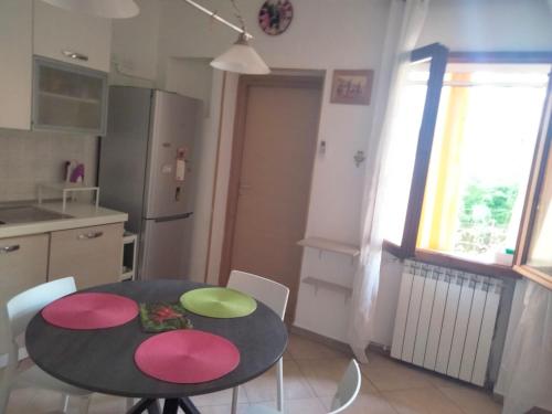 a kitchen with a table and chairs in a kitchen at Stefy House in Lastra a Signa