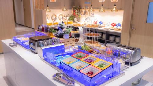 a buffet with food in plastic containers on a table at Holiday Inn Express Chengdu Wuhou New City by IHG in Chengdu