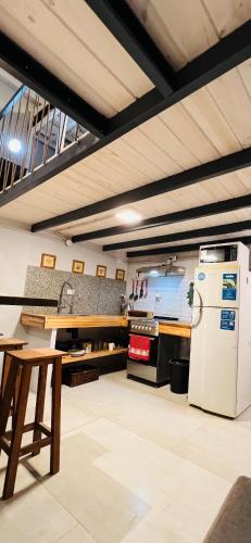a kitchen with a refrigerator and a table at Monica’s Apartments in Canning