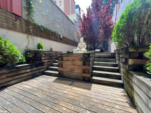 a statue sitting on top of a set of stairs at Home to Home Barcelona in Barcelona