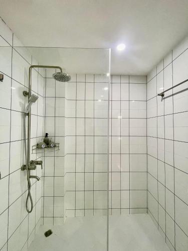 a bathroom with a shower with a glass door at Villa Merry Lao Ban Aphay in Luang Prabang