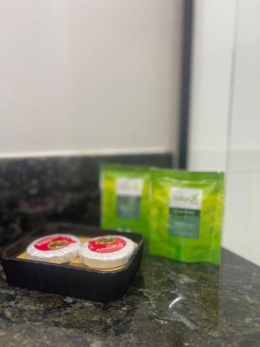 two food items in a pan on a counter at Do Adriano Suites in Búzios