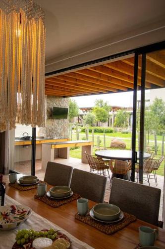 a dining room with a table and chairs and a dining room at Exclusive Luxury Home with Rooftop Jacuzzi in San Miguel de Allende