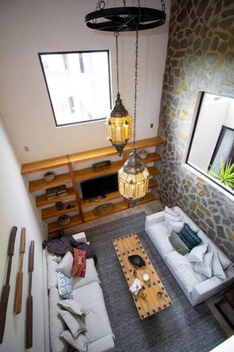 a living room with two couches and a table at Exclusive Luxury Home with Rooftop Jacuzzi in San Miguel de Allende