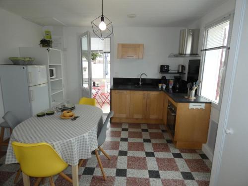 une cuisine avec une table et un ours en peluche dans l'établissement Maison de vacances à Notre-Dame-de-Monts - 4 pers, proche forêt, terr., animaux OK - FR-1-540-281, à Notre-Dame-de-Monts