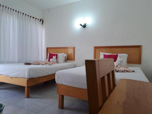 two beds in a room with two beds sidx sidx sidx at Hotel Quinta Paraiso in Cocoyoc