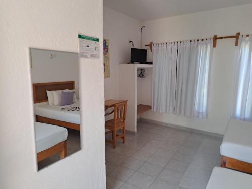 a small bedroom with a bed and a table at Hotel Quinta Paraiso in Cocoyoc