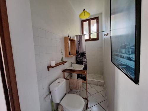a bathroom with a toilet and a sink at Petite Anse in Terre-de-Haut