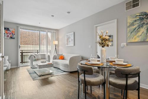 a living room with a table and chairs at Le Reve , 5 min to the beach Luxury Condo in Los Angeles