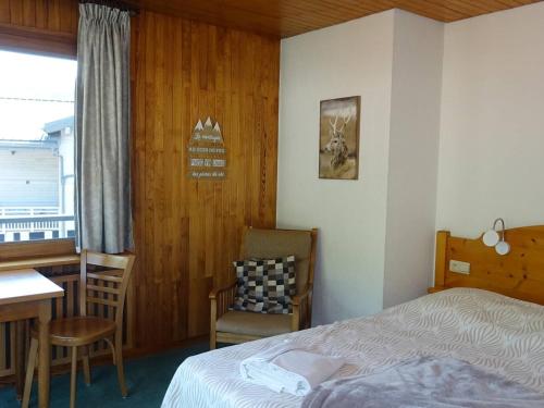 une chambre avec un lit, un bureau et une chaise dans l'établissement À Louer Les Gets: 2 Pièces, 4 Pers, Centre, Wifi, Draps et Serviettes Inclus - FR-1-802-23, aux Gets