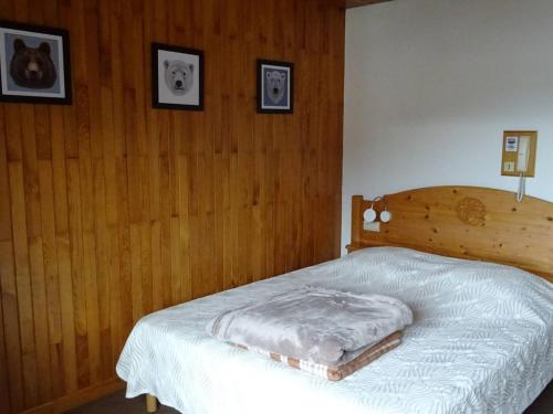 une chambre avec un lit avec une tête de lit en bois dans l'établissement Studio aux Gets, 2 pers, centre-ville, Wifi, draps et serviettes inclus - FR-1-802-26, aux Gets