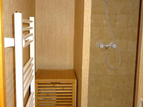une salle de bain avec une douche avec un meuble en bois à l'intérieur dans l'établissement Grand studio duplex lumineux - 6 pers - centre Les Gets - parking privé - à 400 m des pistes - FR-1-802-37, aux Gets