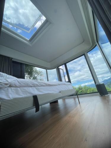 a bedroom with a bed in a room with large windows at 深山林內民宿 in Zhushan