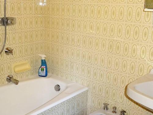 La salle de bains est pourvue d'un lavabo et d'une baignoire blanche. dans l'établissement Spacieux 2 Pièces au Coeur des Gets - 4 Pers - Balcon, WiFi, Draps et Serviettes Inclus - FR-1-802-53, aux Gets