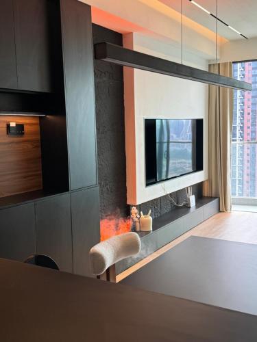 a living room with a tv and a fireplace at Luxury AI Smart Home in KL in Kuala Lumpur