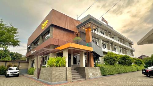 a building with a car parked in front of it at Citrus-House com Hotel in Bogor