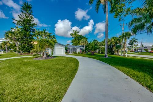 a walkway through a park with palm trees at Villa De Vil in Cape Coral