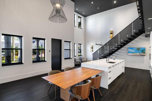 a kitchen with a dining table and a staircase at Modern City Loft in Downtown River District in Fort Myers