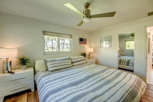 a bedroom with a bed and two windows at Villa De Vil in Cape Coral