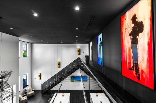 a staircase in a building with paintings on the walls at Modern City Loft in Downtown River District in Fort Myers