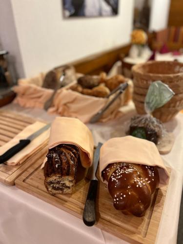 two sandwiches on a cutting board on a table at Hotel Garni Martina in Ischgl