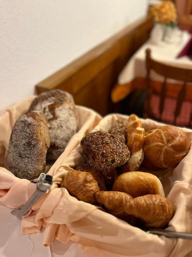 a basket of different types of pastries on a table at Hotel Garni Martina in Ischgl