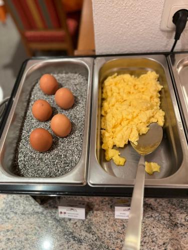 two trays of eggs and rice on a counter at Hotel Garni Martina in Ischgl