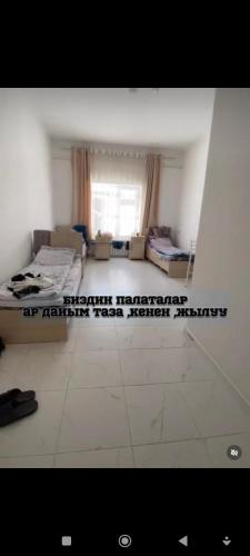 an empty room with a bed and a window at Аксы санатория in Kerben