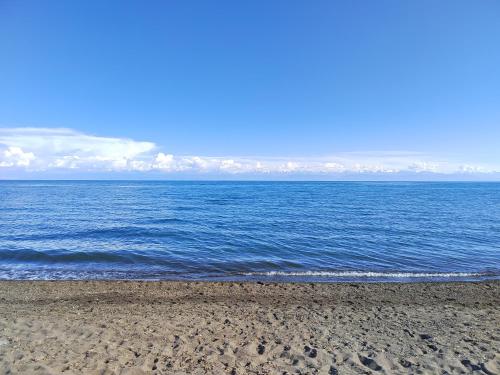 a view of the ocean from a sandy beach at У Дяди Жени in Temirovka