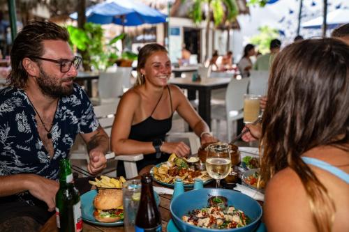 a group of people sitting around a table eating food at Manta Dive Gili Trawangan Resort in Gili Trawangan