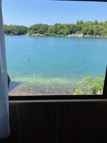 a view of a lake from a train window at Yadokari Shima in Shima