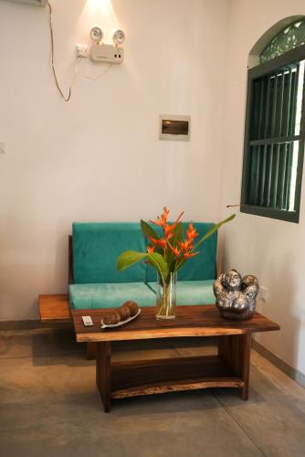 a living room with a green couch and a coffee table at Villa Hillcrest in Weligama