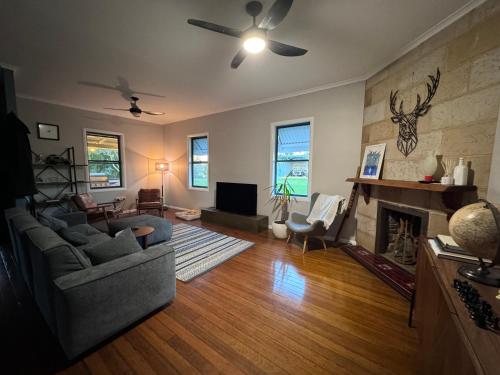 a living room with a couch and a fireplace at Farm stay on the river in Langley Vale
