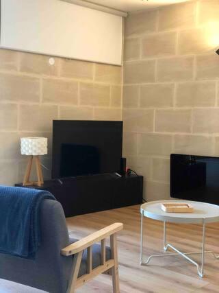 a living room with a couch and a table at Maison de ville paisible in Lormont
