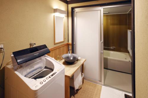 a kitchen with a sink and a bowl on a counter at Heiankyu-dairi no yado in Kyoto