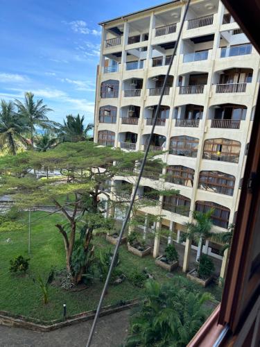 a view of a large building from a window at Sea la Blue in Ukunda