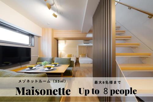 a living room with a couch and a table at TAKUTO STAY SAKAISUJI-HOMMACHI in Osaka