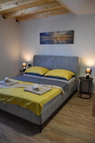 a bedroom with a bed with yellow pillows on it at Apartments Rismondi 37D in Fažana