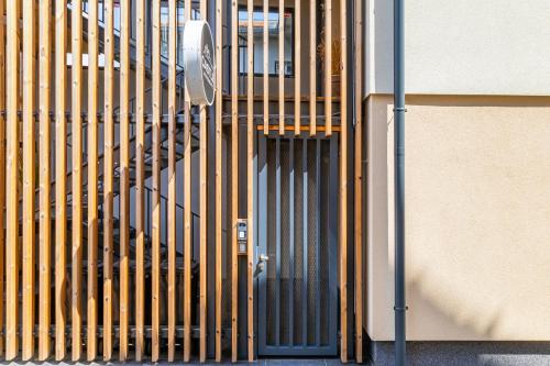 a building with a metal door and stairs on it at CASTLE apartments - City Center in Spišské Podhradie