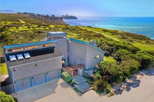 an overhead view of a house with the ocean in the background at Unmatched Ocean Beach and Mountain Views Family-Friendly Retreat in Moss Beach