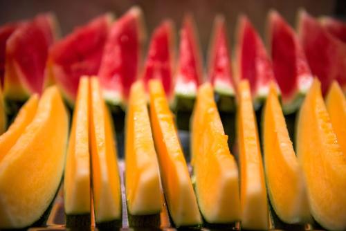 a row of orange and red fruit on a table at Atour Hotel Guangzhou Sanyuanli-Guangzhou Baiyun Railway-Fiee Self-Service Laundry in Guangzhou