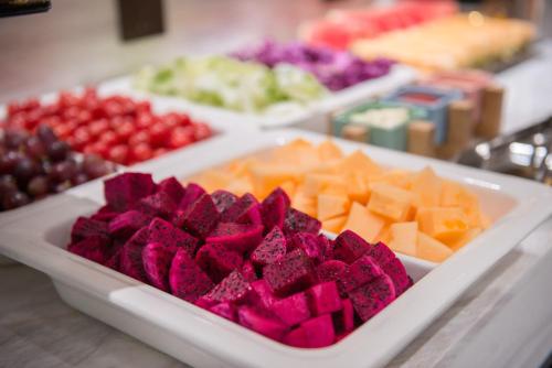a tray filled with different types of cheese and fruit at Atour Hotel Guangzhou Sanyuanli-Guangzhou Baiyun Railway-Fiee Self-Service Laundry in Guangzhou